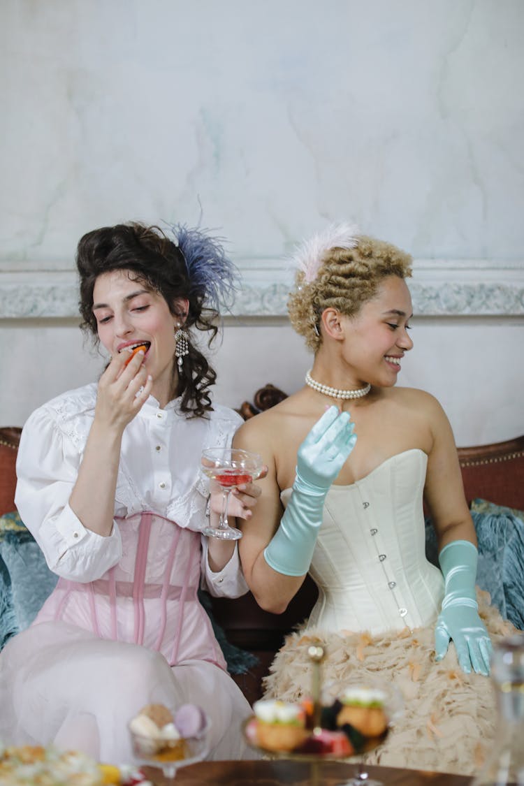 Women Wearing Corset Dress Eating Together 