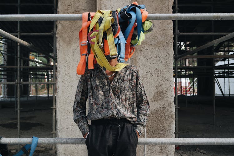 Man Standing Behind Security Belts On A Construction Site 