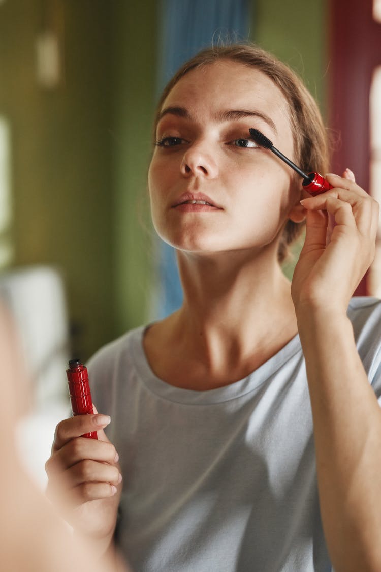 Pretty Woman Applying Mascara On Eye Lashes