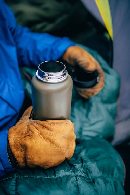 Person Holding a Thermos