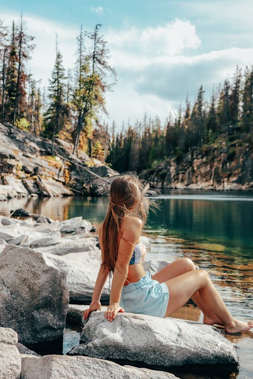 Woman in Tube Top Sitting on Riverside