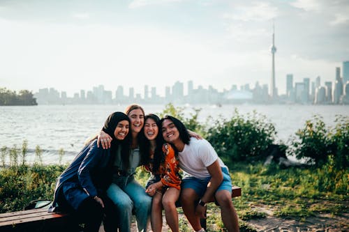 Friends Sitting on Wooden Bench 