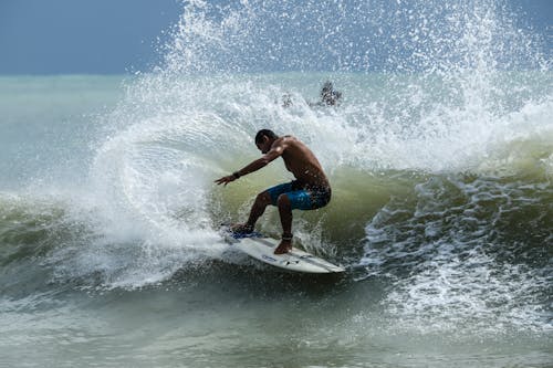 Free Man Surfing on Sea Stock Photo
