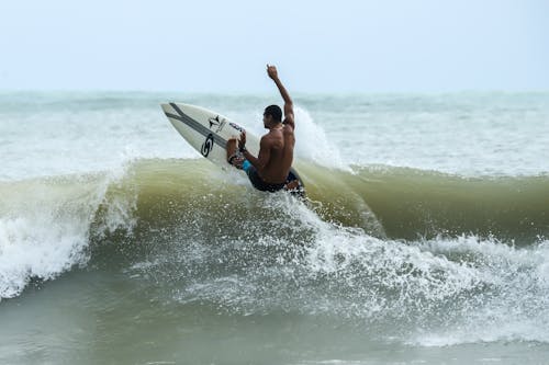 A Man Surfing on Sea Waves