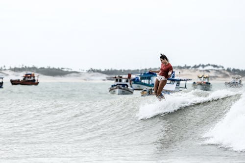 Woman Surfing on Sea