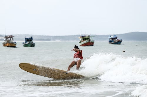 A Woman Surfing on Sea