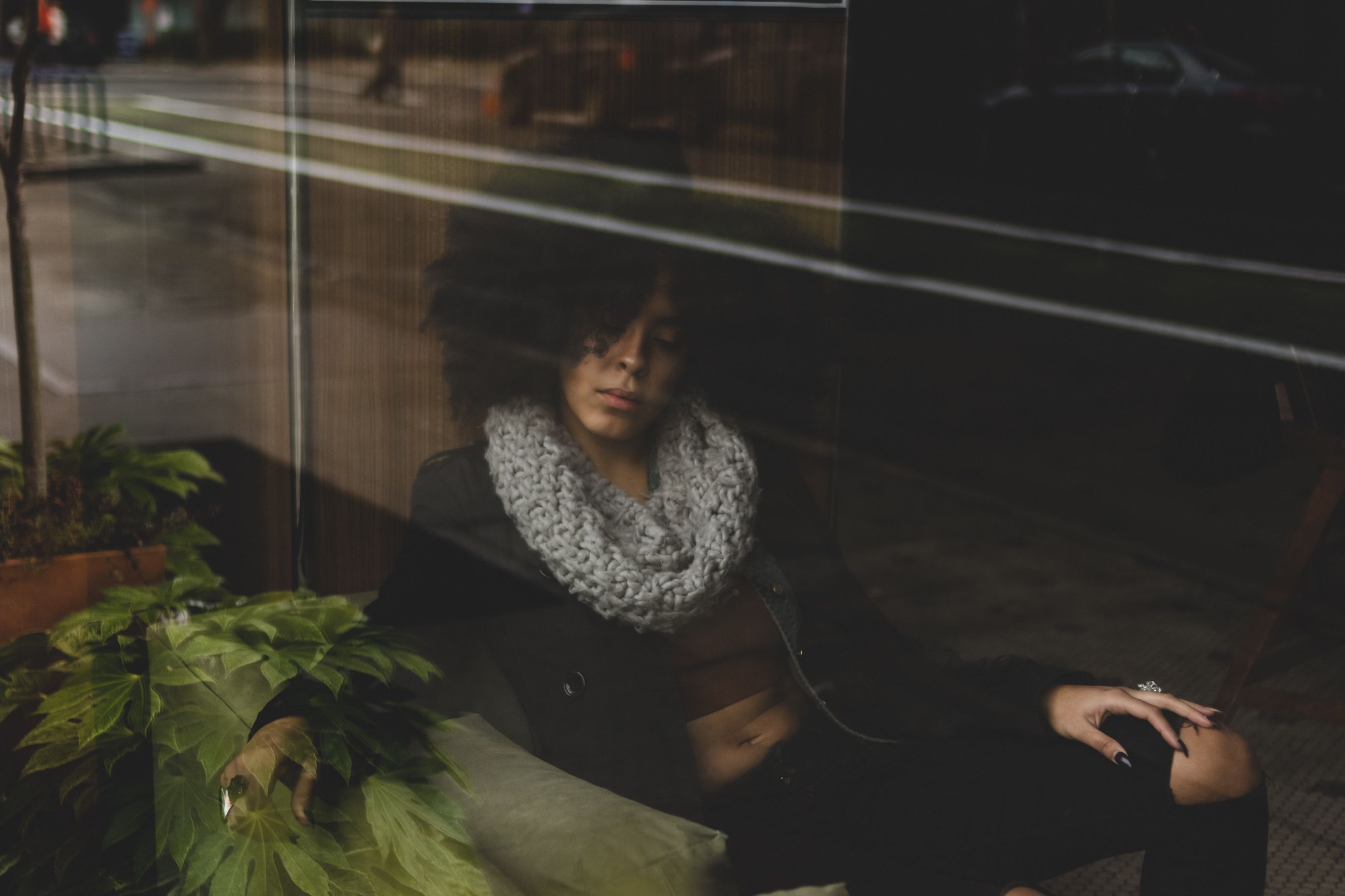 A Woman Sitting Beside the Glass Window · Free Stock Photo