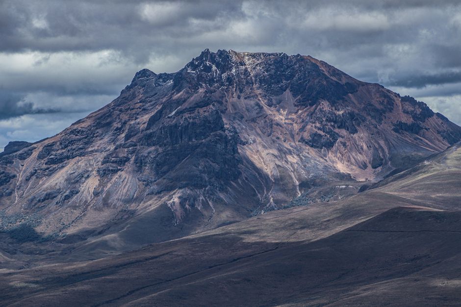 Breathtaking Ecuadorian Cooking Classes Rooftop (English) Review: A Delicious Cultural Expedition in Quito Review 2026 - A dramatic view of Cotopaxi volcano in Ecuador, captured under a cloudy sky, showcasing its rugged terrain.