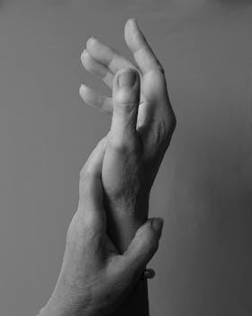 Artistic grayscale image of intertwined female hands, expressing emotion and connection.