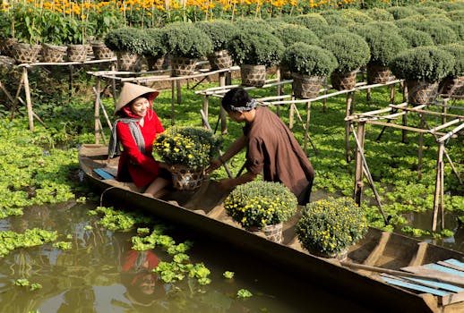 Two people on a boat transporting flowers in Sa Dec, Vietnam.