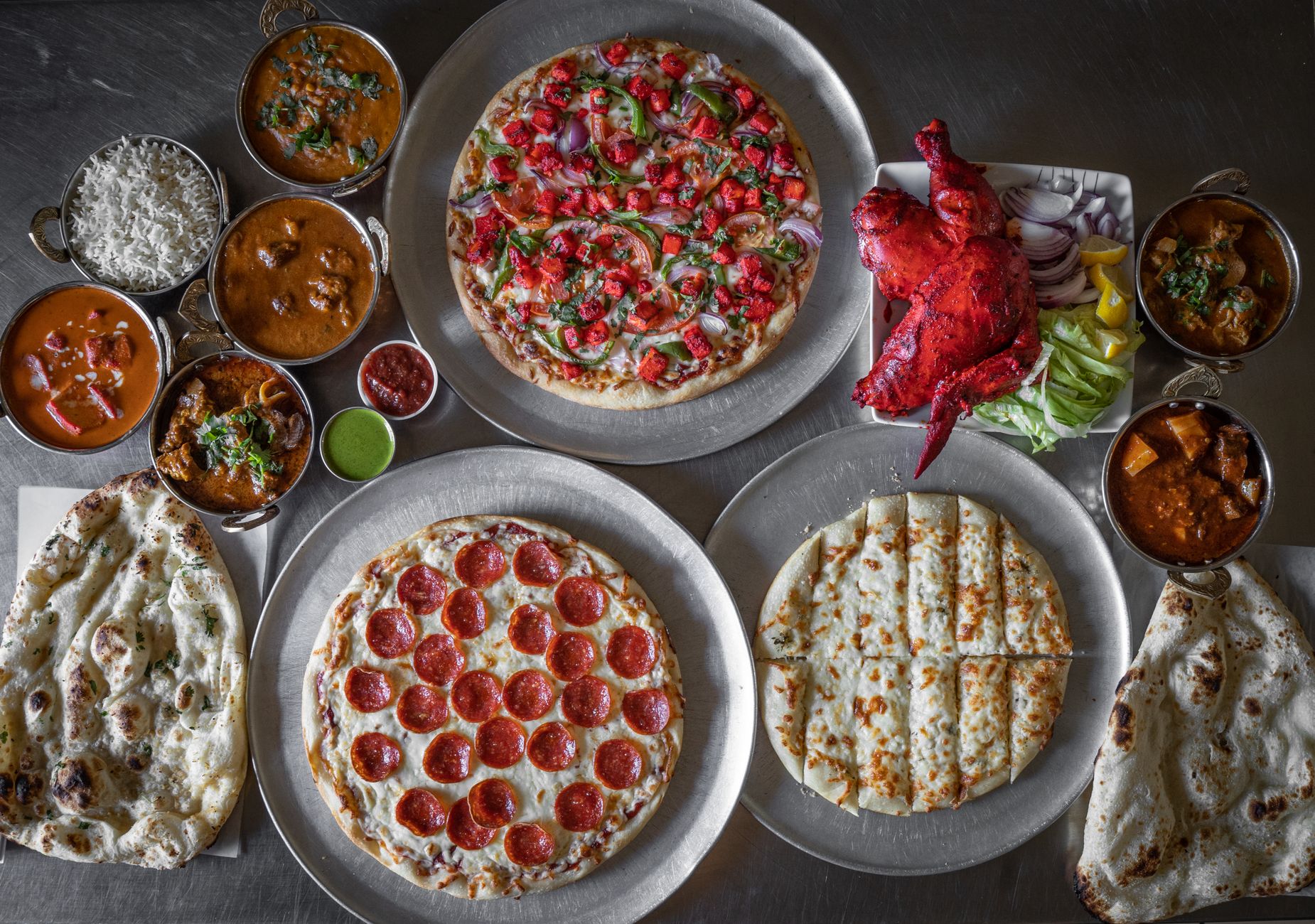 Close up of Indian fusion pizza with vibrant toppings