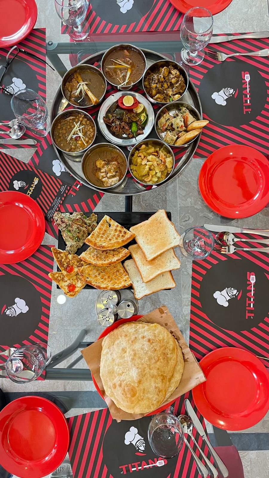 Flat lay of a Pakistani thali with breads and dishes