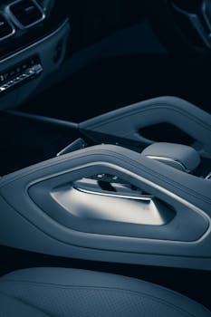 Close-up view of a sleek gear shift in a modern luxury car interior highlighting sophistication.