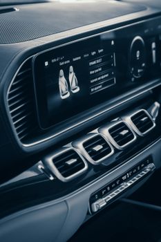 Close-up of a luxurious car interior showcasing the dashboard with a digital screen.