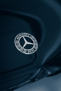 Detailed close-up of a Mercedes-Benz emblem with elegant reflections. 9792973
