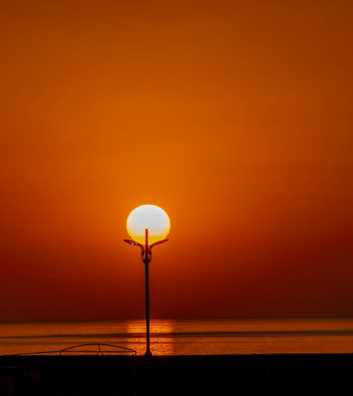 Silhouette of Light Post during Sunset