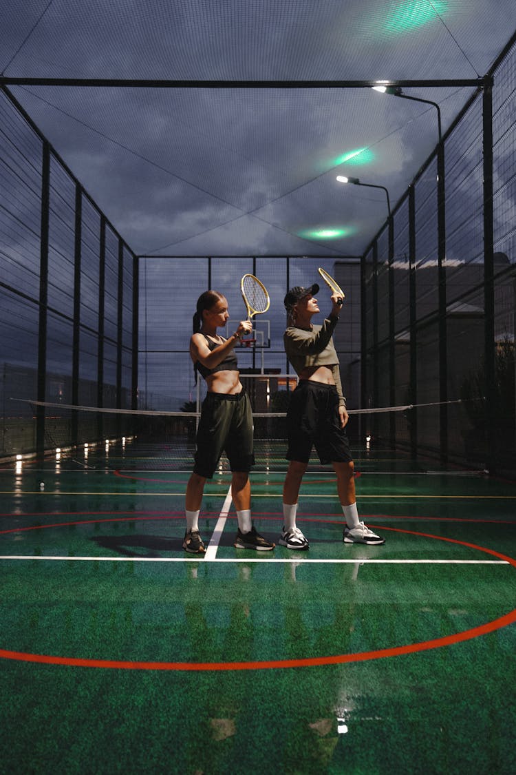 Girls With Rackets On Outdoor Field