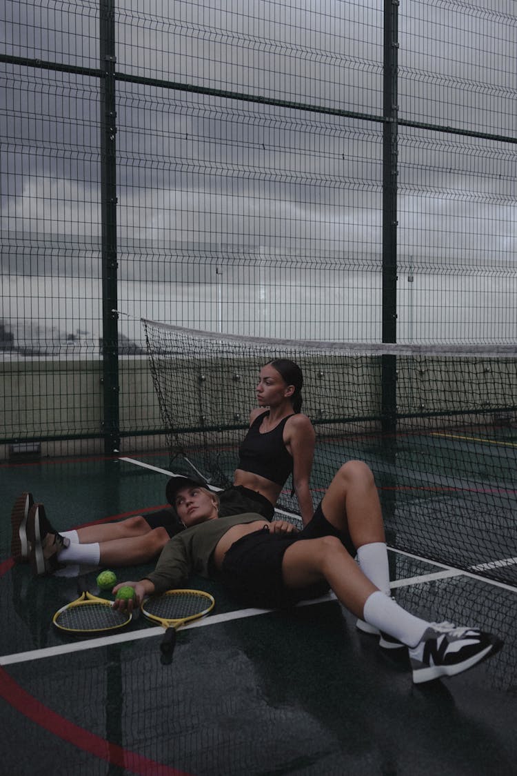 Woman And Man Posing On Tennis Court