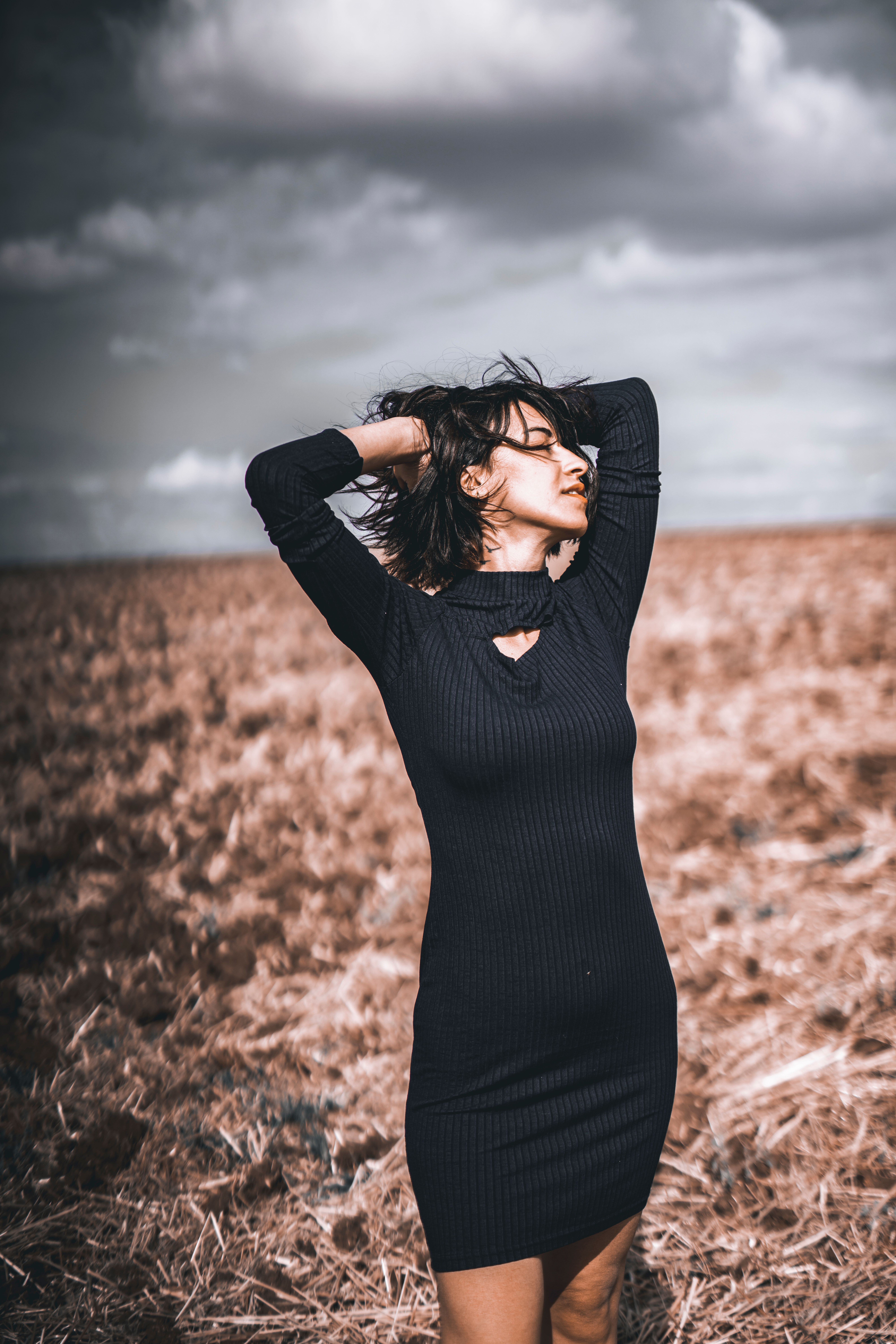 Woman in Floral Dress Standing on Brown Grass Field · Free Stock Photo