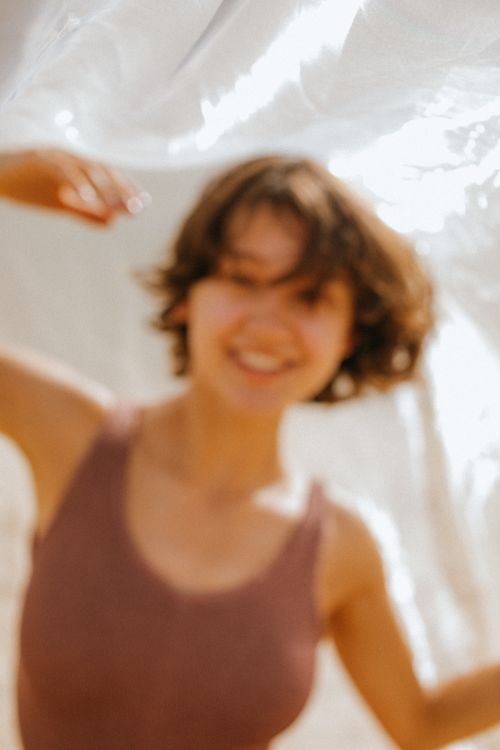 Free A cheerful blurry portrait of a woman in sunlight, expressing joy and freedom. Stock Photo