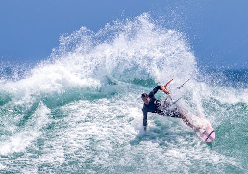 Free Man Surfing on Board in Ocean Wave Stock Photo