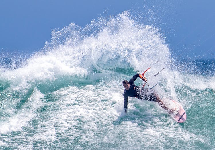 Man Surfing On Board In Ocean Wave