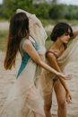 Women posing with see-through fabric