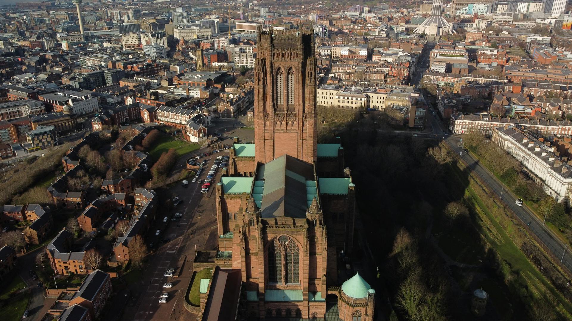 Drone shot capturing the iconic Liverpool Cathedral and surrounding cityscape.