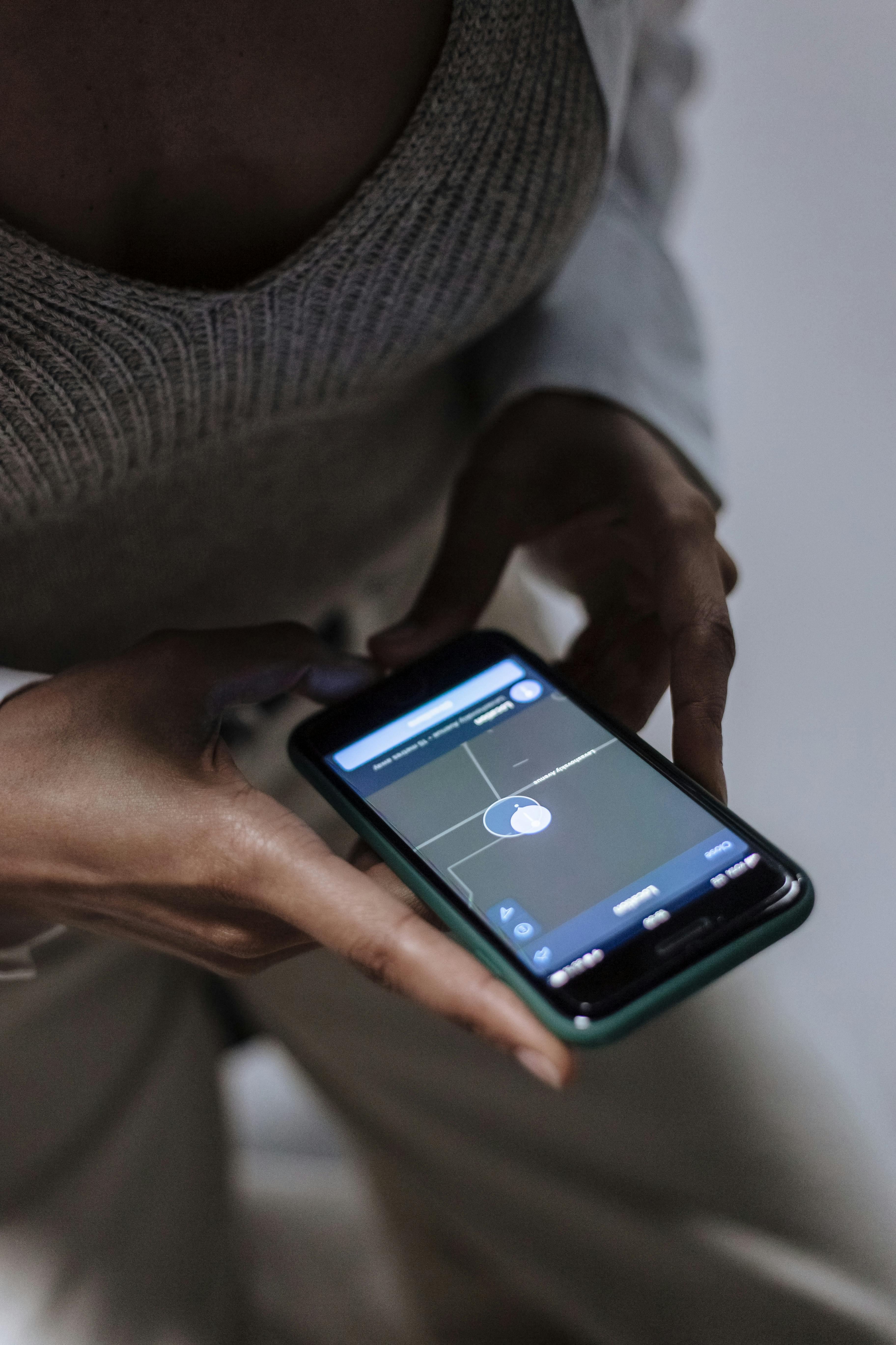 woman holding phone with parental control application