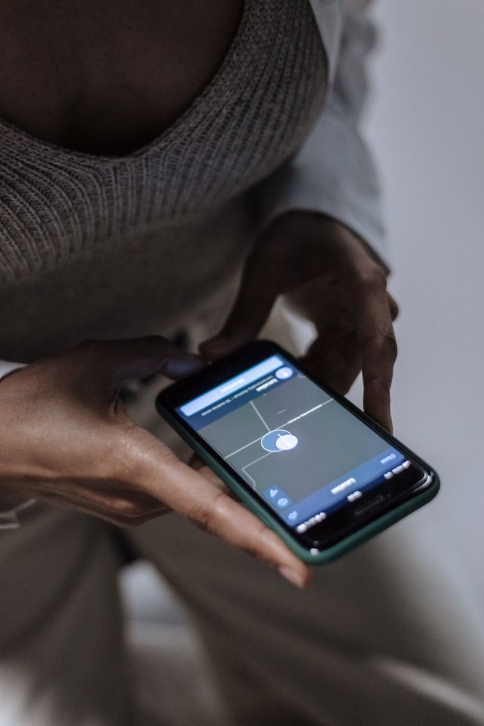 Close-up of a phone displaying a location-tracking app
