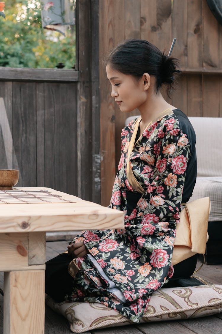 Woman Sitting By Table