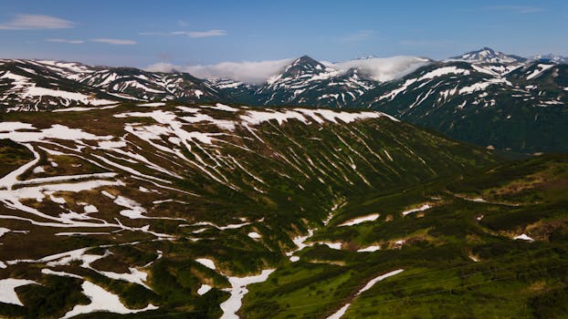 A breathtaking aerial view of snow-striped mountains in Kamchatka, Russia during late winter.