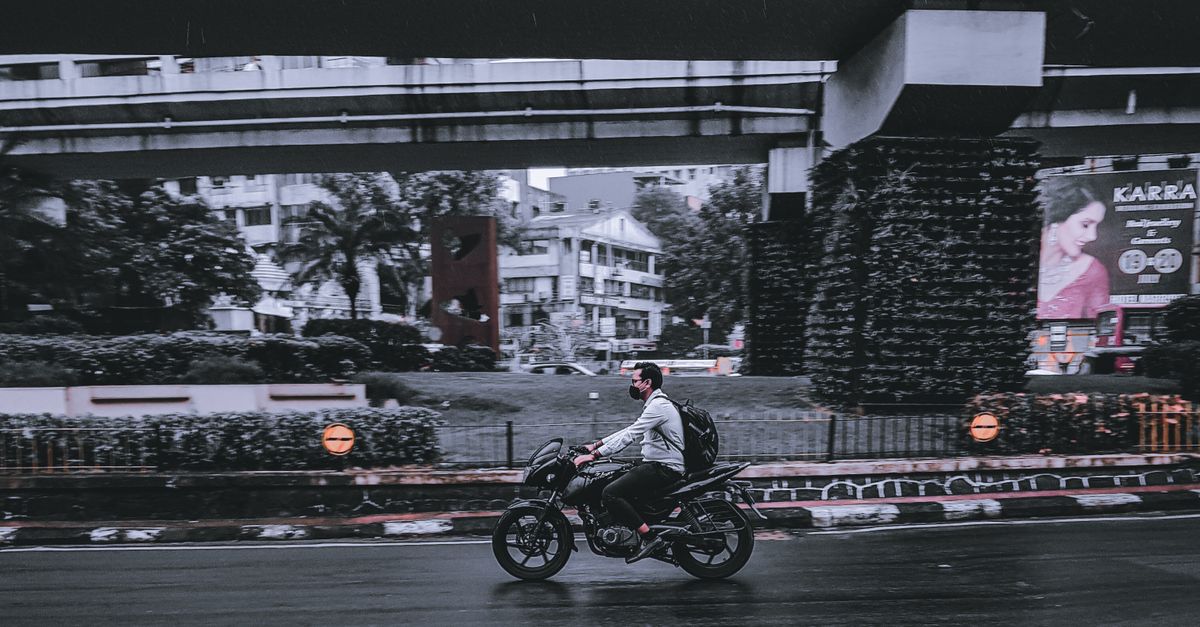 Man Rode Image Photo of a Man Riding a Motorcycle on a Road · Free Stock Photo
