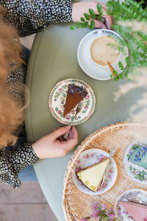 Free An overhead view of coffee and cake on a floral table setting, capturing a moment of relaxation. Stock Photo