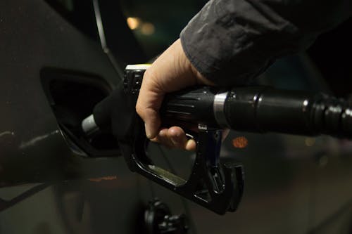 Free Person Holding Gasoline Nozzle Stock Photo
