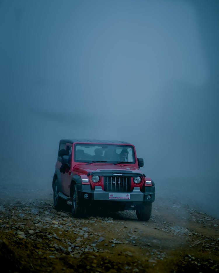 A Red Mahindra Thar On Dirt Road