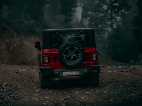 A Red Mahindra Thar on Dirt Road