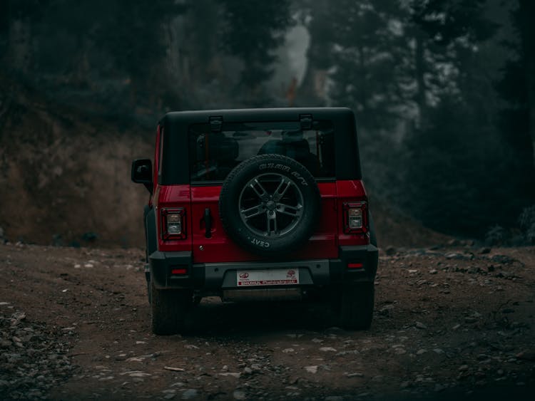 A Red Mahindra Thar On Dirt Road