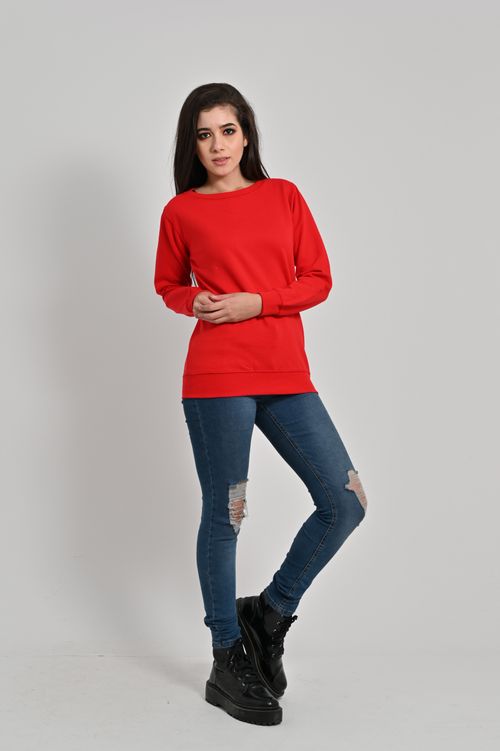 Free Elegant woman in a red sweater poses confidently wearing jeans and boots. Style and fashion concept. Stock Photo