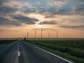 Black Asphalt Road Between Green Grass Field Under Cloudy Sky