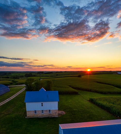 Free Captivating aerial sunset view over a tranquil rural farm in Minnesota, showcasing vibrant landscapes and expansive fields. Stock Photo