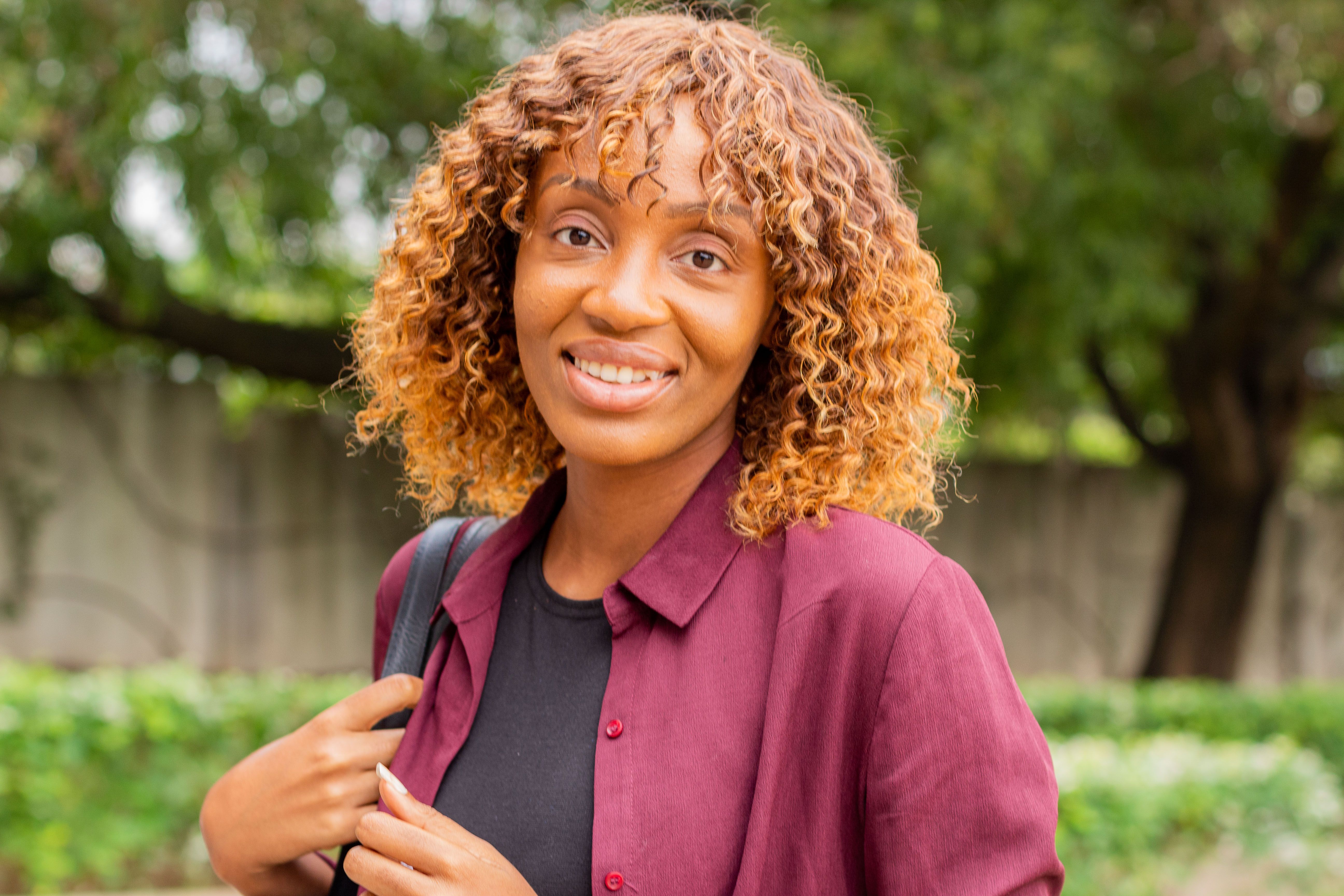 Portrait of a Beautiful Woman with Brown Curly Hair · Free Stock Photo