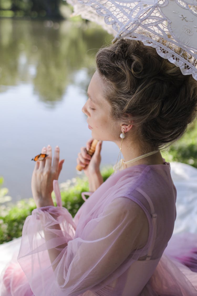 A Women In Lace Dress Holding An Umbrella