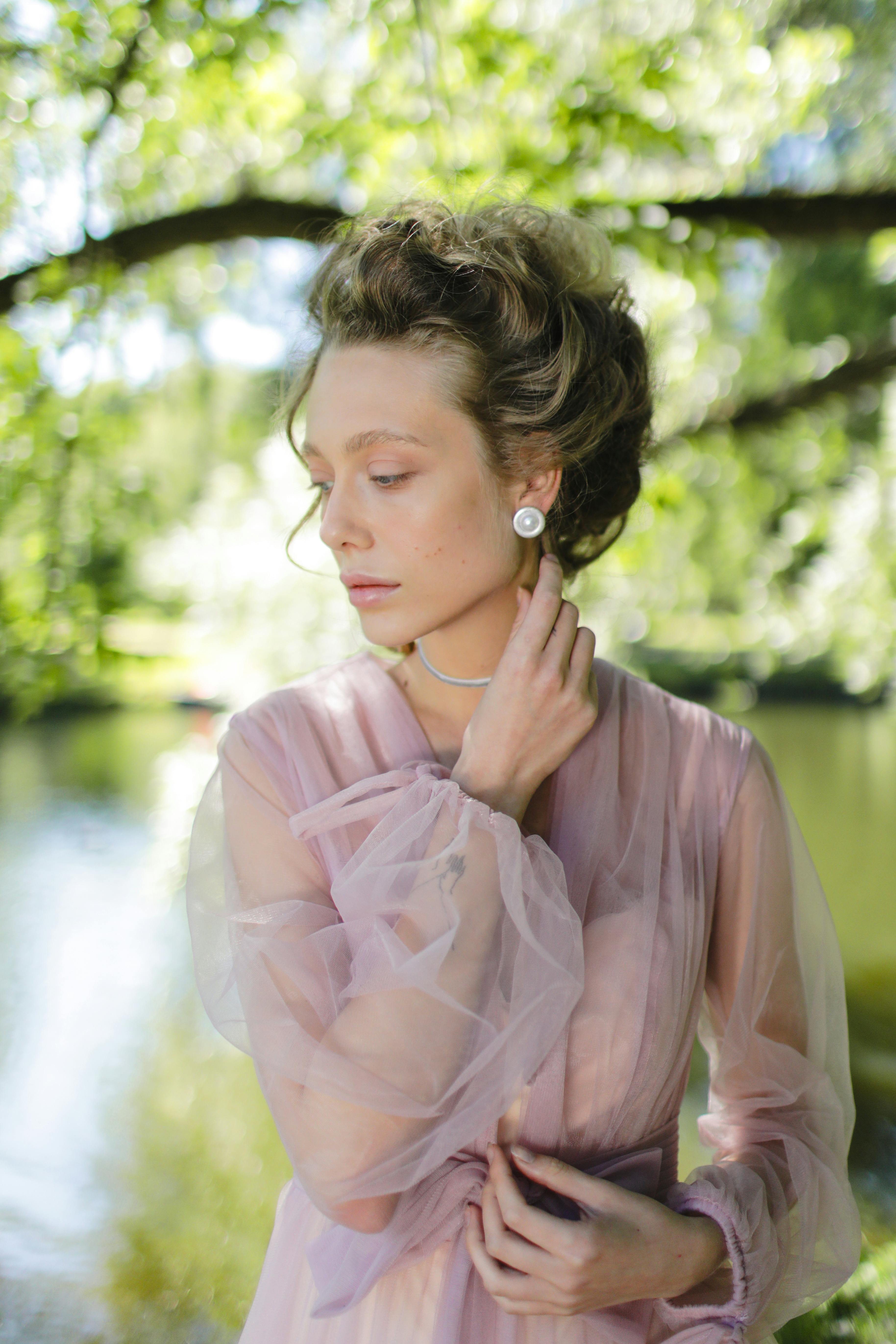 woman in long sleeves wearing pearl earrings