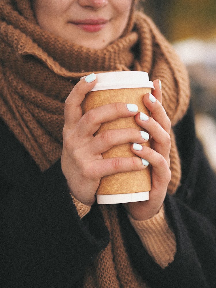 Woman In Warm Clothes Holding Paper Coffee Cup