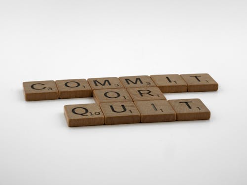 Brown Wooden Scrabble Tiles on White Surface