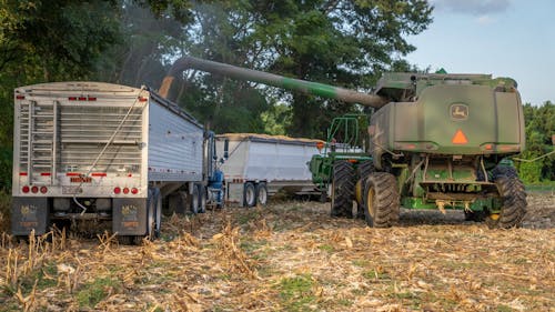 Combine Dumping Grain onto Trailer