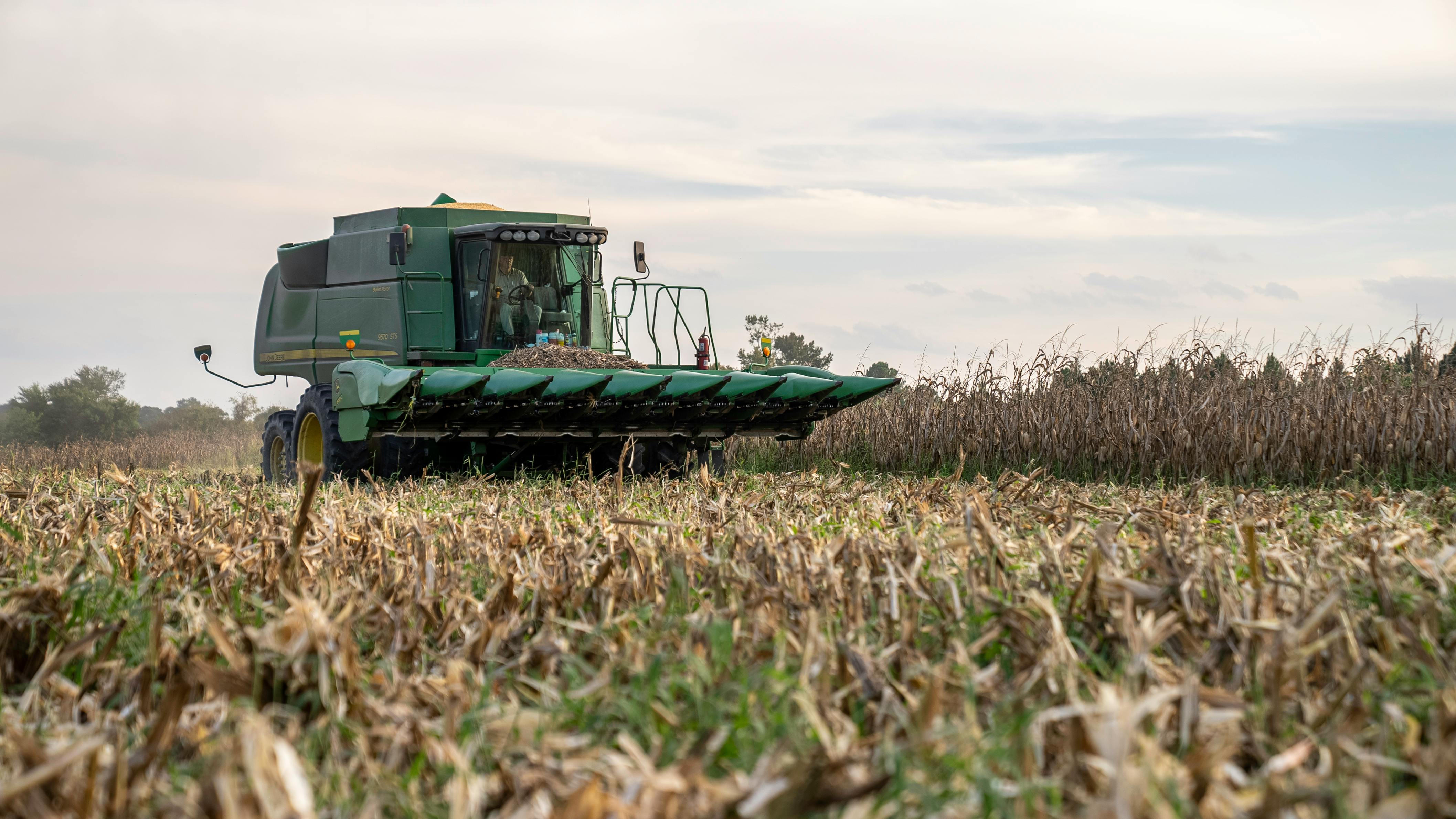 Blue Tractor Next to White Farm Vehicle at Daytime · Free Stock Photo