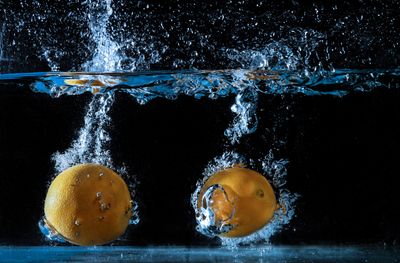 Lemons splashing into water — photo by Владимир Парадный on Pexels