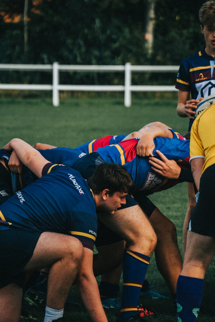 Men In Formation Playing Rugby